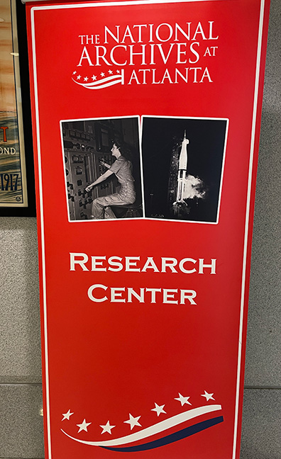 National Archives at Atlanta Research Center sign with images from the Manhattan Project and NASA.